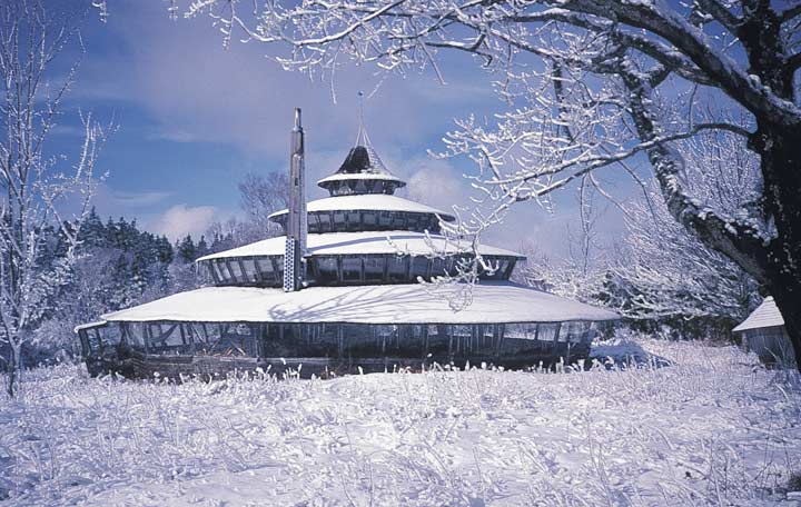 The yurt shown in the three photos on this page is Bills home in the Maine woods. It is 54' (eaves) in diameter and was designed so it could be built over a period of several years and still provide shelter during the process. It is a tri-centric, or three-ring yurt with 2700 sq. ft. of floor space. You can first build the 16' inner core as a room to move into. In the second stage, you can build the large sheltering roof over a gravel pad, allowing the major cost, floor construction, to be delayed. In the meantime you have a spacious area under roof that can be used for a workshop, greenhouse, garage, or for play.