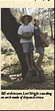 Bill with intern Lori Wright standing on arch made of clay and straw
