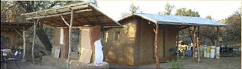 Structure (“bus stop”) used for seating during workshops. Local juniper poles, straw bale walls, seat is from blocks made from sawdust and clay during a workshop. As soon as they came out of mold, they were placed into seat wet to be able to form curves. Behind it is straw bale storage shed for lime and clay putties so they don’t freeze; other dry plaster materials are stored on the outside.